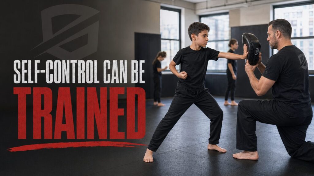 Boy practicing a controlled palm strike with a Krav Maga instructor to build focus and self-control.